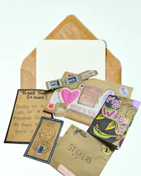 a collection of cards, envelopes, and other items on a table
