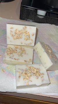 three bars of soap with oats on top