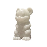 a white figurine of a mouse sitting on a white surface