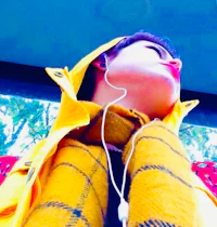 a woman wearing a yellow jacket and earphones