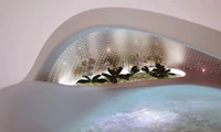 a hot tub in a room with a light on it