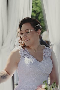 a bride in a white dress holding a bouquet