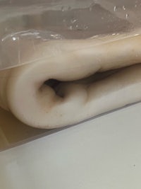 a piece of plastic wrapped around a piece of dough