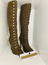 a pair of green suede boots with gold studs