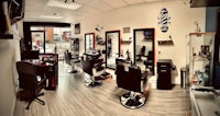 a barber shop with a lot of chairs and equipment