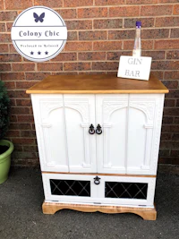 a white cabinet with the words colony chic on it