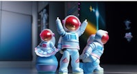 a group of astronaut figurines are standing in a room