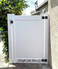 a white gate with a black handle on it