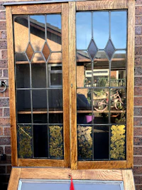 a stained glass window in front of a brick wall