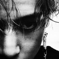 a black and white photo of a man with long hair