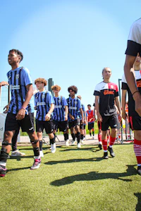 a group of soccer players walking on a field