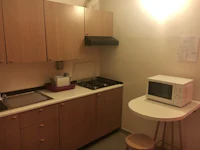 a small kitchen with a microwave and refrigerator
