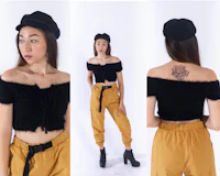 a woman wearing a black crop top and yellow pants