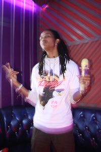 a woman with dreadlocks holding a microphone