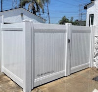 a white fence in front of a house