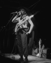 a man in a cowboy hat singing into a microphone