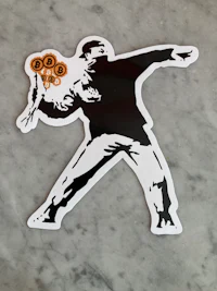 a black and white sticker of a man jumping on a marble surface
