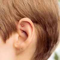 a young boy with a piercing in his ear