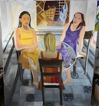 three women sitting at a table in front of a painting