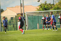 a group of men playing soccer on a field