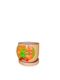an orange and green planter with a face on it