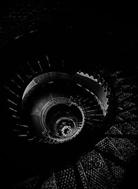 a black and white photo of a spiral staircase