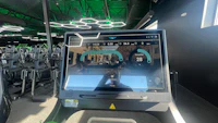 a treadmill in a gym with a screen on it