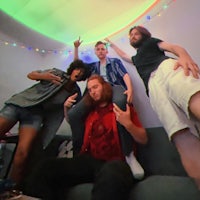 a group of people are posing on a couch in a living room