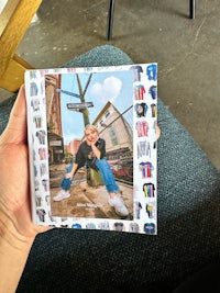 a person holding up a card with a picture of a person