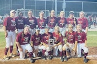 a group of softball players posing for a picture