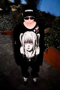 a person wearing a black t - shirt and sunglasses