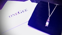 a necklace with the word onegee on it