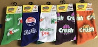 six pairs of socks with different soda brands on them
