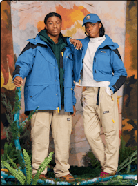 two people posing for a photo in a blue jacket and khaki pants