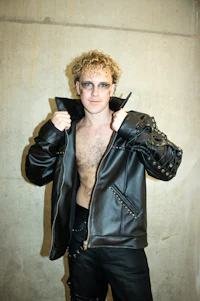 a man in a leather jacket posing for a picture