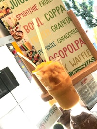 a drink with a straw sitting on top of a display