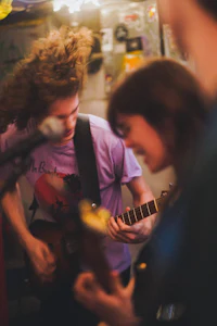 a group of people playing guitar in a room