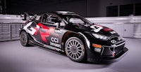 a black and white rwc car is parked in a garage