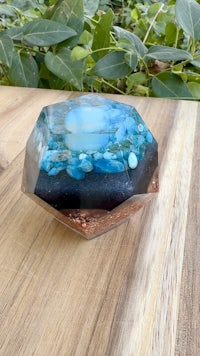a blue and white glass bowl sitting on top of a wooden table