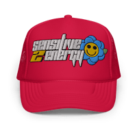 a red trucker hat with a smiley face on it