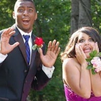 a man and a woman in formal attire are posing for a photo