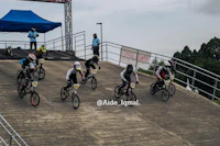 a group of people riding bikes on a ramp