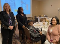a group of people posing for a photo in a conference room