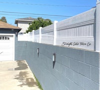 a white fence with a sign on it
