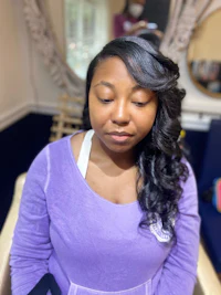 a woman in a purple shirt sitting in a chair