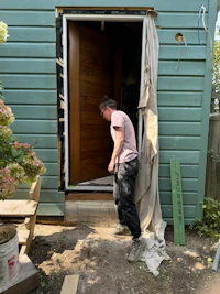 a man standing in front of a wooden door