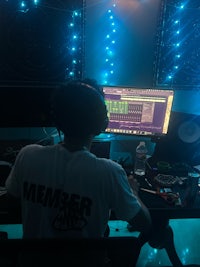 a man sitting at a desk in front of a computer