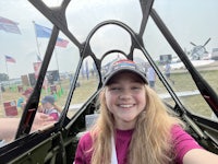 a girl is taking a selfie inside a plane