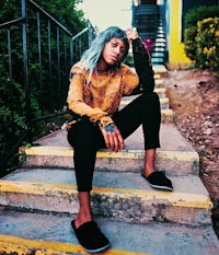a woman sitting on a set of stairs