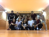 a group of people posing for a photo in an indoor court